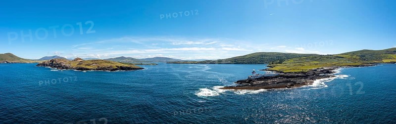 An aerial panorama of the coastal landscape of the Iveragh Peninsula with Beginish and Valentia Island Lighthouse