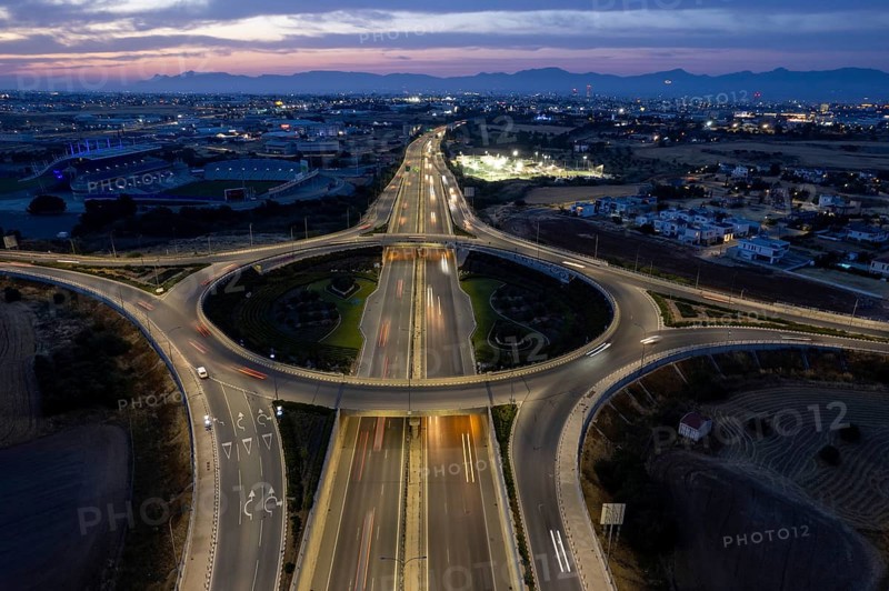Aerial drone top view of a modern motorway junction roundabout with cars moving fast. Transportation infrastructure, Nicosia Cyprus