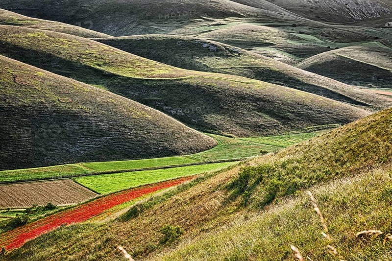 The sun, when it rises behind Mount Vettore, creates a light-shadow effect in the hills below