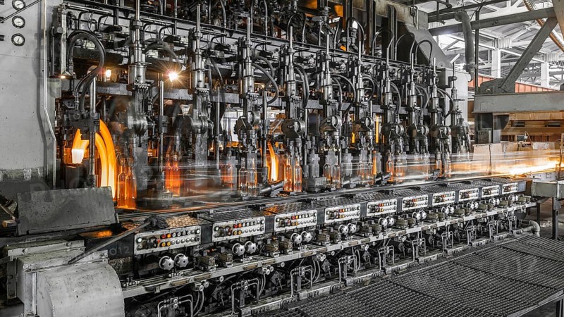 On the conveyor glass bottles are pasteurized with fire. factory shop for the production of glass bottles and beverage