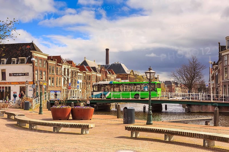 Leiden, Netherlands, April 7, 2016: Street view with traditional houses, bridge and people in Leiden, Holland