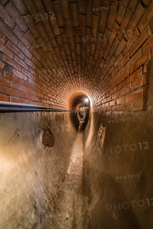 Anderlecht, Brussels, Belgium, 07 16 2019- Industrial interiors of the sewer museum showing an rebuild old fashioned brick stone tunnel, Europe