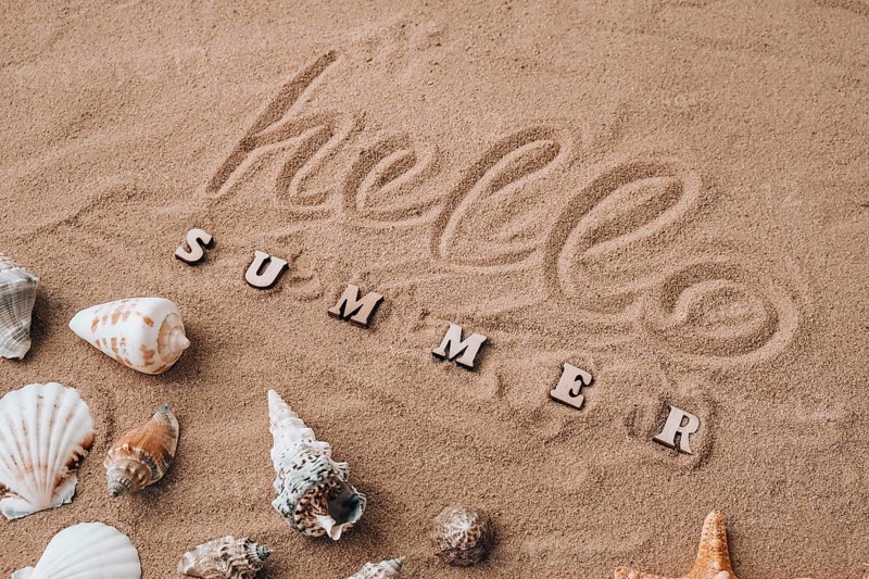 Composition with text HELLO SUMMER seashells, pebbles, mockup on sand background. Blank, top view, still life, flat lay. Sea vacation travel concept tourism and resorts. Summer holidays