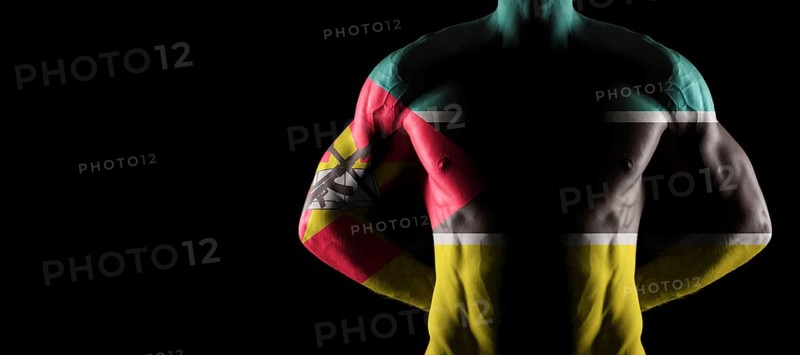 Mozambique flag on muscled male torso with abs, black background
