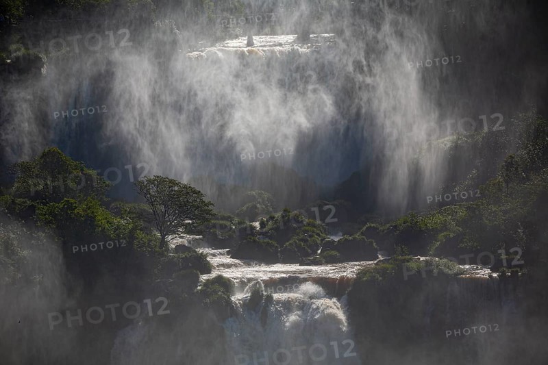 Mystical view to waterfall cascades with a wall of spray and sunlight, Iguazu Falls, Misiones, Argentina, South America