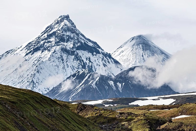 Nature of Kamchatka Peninsula, beautiful volcanic landscape: view on Kamen Volcano, active Klyuchevskoy Volcano and active Bezymianny Volcano. Russia, Far East, Kamchatka