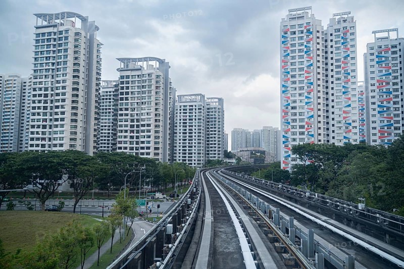 30.07.2023, Singapore, Republic of Singapore, Asia, View from a fully automated shuttle train of the Sengkang LRT Line onto typical HDB (Housing and Development Board) residential high-rise buildings of public housing in the Sengkang district, Asia