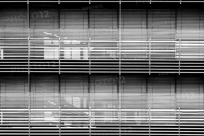 The modern façade of a chemical building and laboratory with highly light-reflecting metal blinds for solar shading