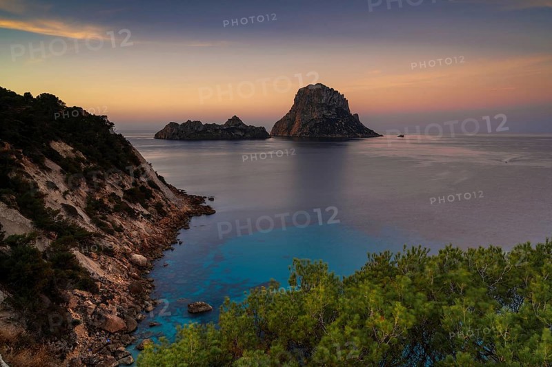 A view of the landmark Es Vedra island and rocks off the coast of Ibiza at sunrise