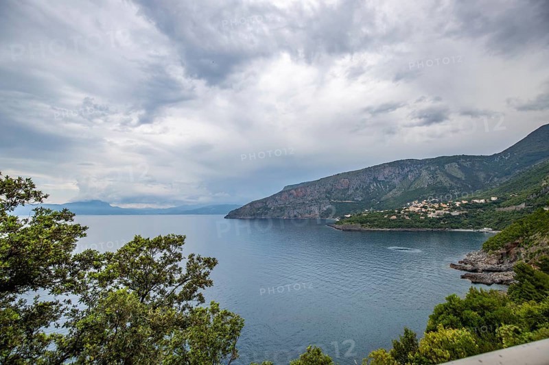 Coastal landscape shot. View from a road leading along the sea and through a breathtaking green Mediterranean landscape. Coast near Salerno, Italy, Europe