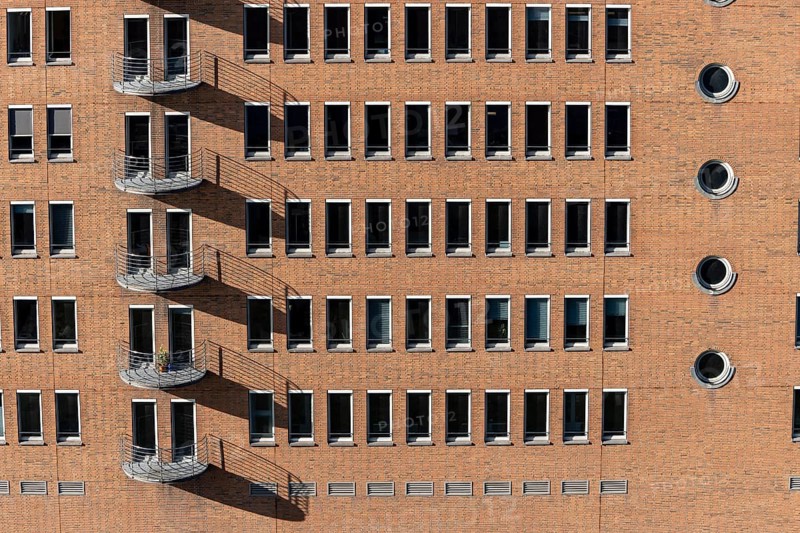 Red brick building with balconies and square and round windows in the Speicherstadt, Hafencity, Hanseatic City of Hamburg, Hamburg, Germany, Europe