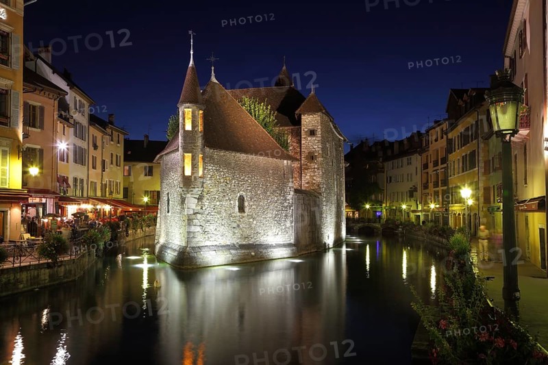 The capital of the Haute-Savoie - Annecy. The main attraction of the city - an ancient fortress-prison on an island in the middle of the river. Fortress beautifully lit and is reflected in the smooth water