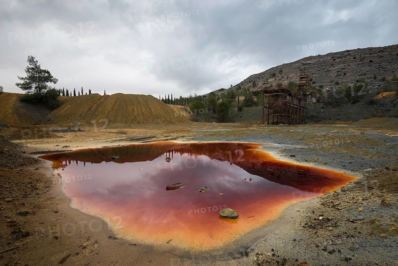 Lake with red polluted toxic water of an Abandoned copper mine at Mitsero area in Cyprus