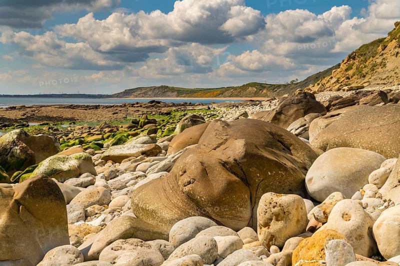 Stones and clouds at Osmington Bay, Osmington Mills, near Weymouth, Jurassic Coast, Dorset, UK