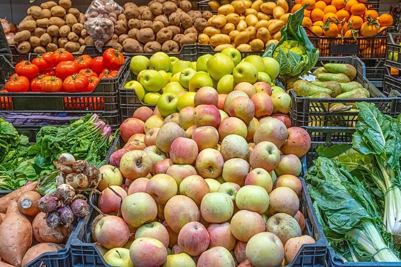 Apples and vegetables for sale at a market