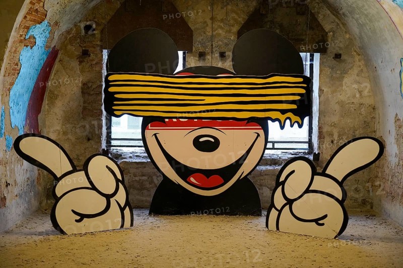 MAUSA VAUBAN, Museum of Urban Art and Street Art, Neuf-Brisach Fortress, France, Europe, A stylised mural of Mickey Mouse with an eye slit, highlighted by bold colours, Europe