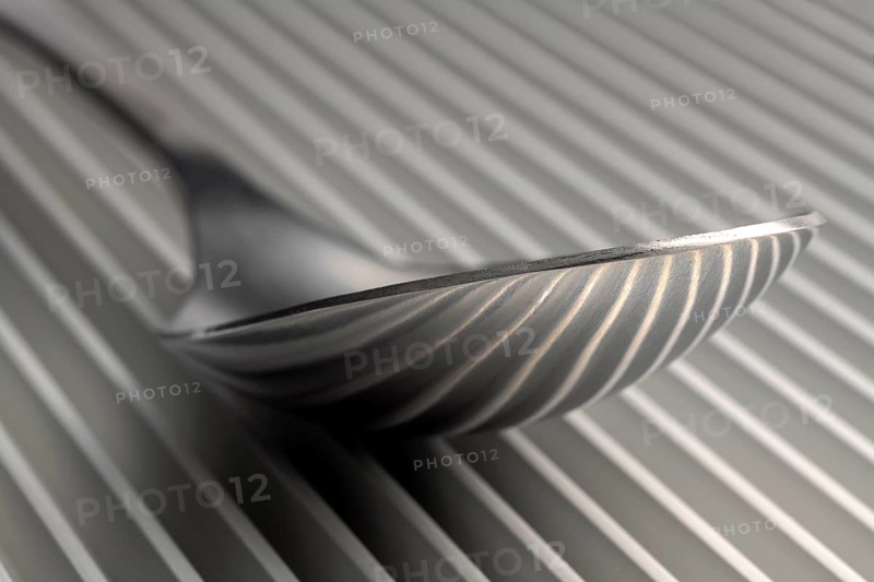 Abstract artistic picture of a spoon on a parallel grid structure