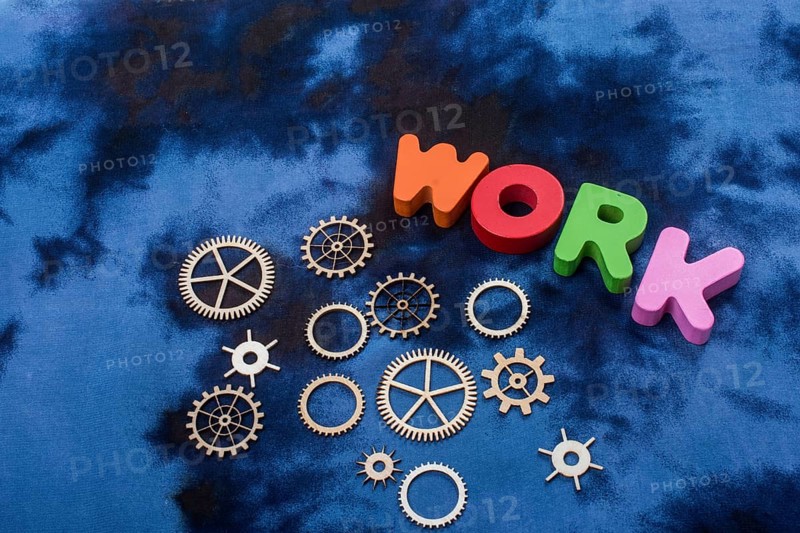 Work wording and wooden cogwheels as industry mechanism concept