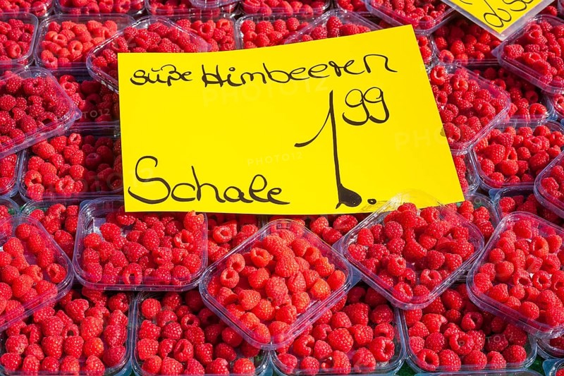 Fresh raspberries in trays with price tag on a market stall for sale, Bremen, Germany, Europe