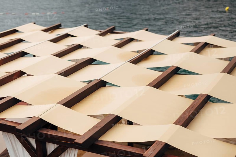 Unusual roof closure. The roof of the restaurant on the street by the sea. The fabric roof. SUMMER TERRASSA