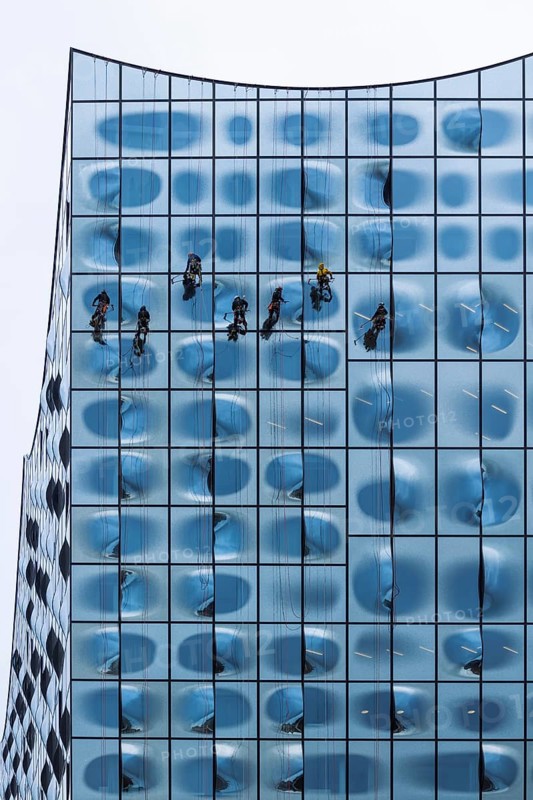 People working as window cleaners on the striking glass façade of a tall building, Elbphilharmonie, Hamburg Concert Hall, Free and Hanseatic City of Hamburg, Germany, Europe