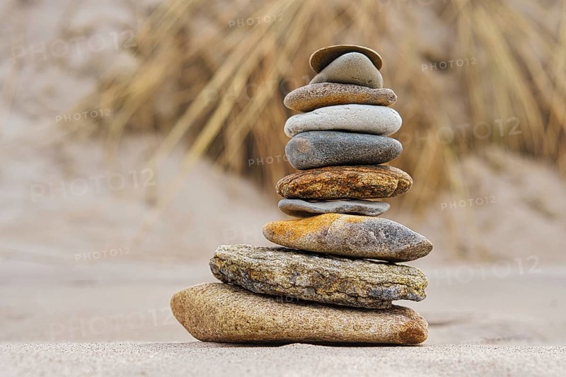 Stone pyramid on the beach at Zingst. Stones stacked on top of each other by the sea