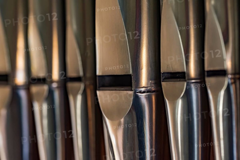 Close-up of lead organ pipes standing in a row in a church