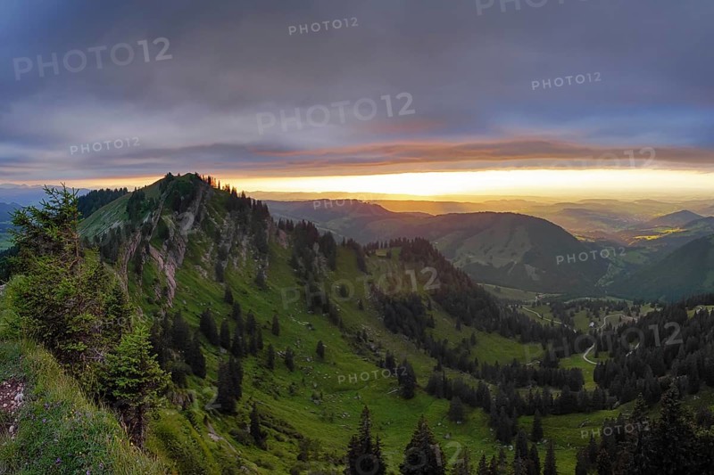 Panoramic view of a light and weather scene over the foothills of the Alps, taken from the Nagelfluhkette, Allgäu. On the right in the background Oberstaufen and on the left the Seelekopf