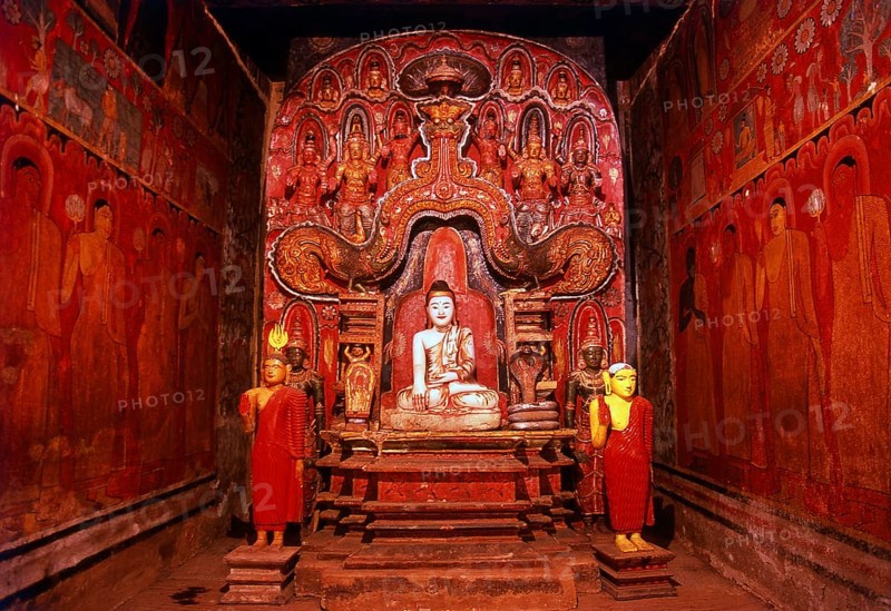 The Medawala Rajamaha Viharaya or Tempitiya Vihara, north of Kandy is a typical <i>tempath vihara</i>, a small wooden image house or shrine, placed on stilts or piles. The <i>tempath vihara</i> can be regarded as Kandy's most significant contribution to Buddhist architecture, but there are not many specimen of its kind left.<br/><br/> Some of the frescoes in the Rajamaha Viharaya depict the king and the royal family, but they also depict the everyday life of the commoners, such as a farmer tilling his field with the help of a white bull. One enigmatic painting shows a recumbent Buddha, sleeping safely tucked away behind a mosquito net.<br/><br/> Though the frescoes exhibit all the hallmarks of the 18th century, the original construction of the Raja Mahavihara is said to go back to much earlier times. Despite the artistic merit of the frescoes, the most remarkable single feature in the image house is the small ivory figure of a Buddha. The figure is surrounded by an intricately carved w...