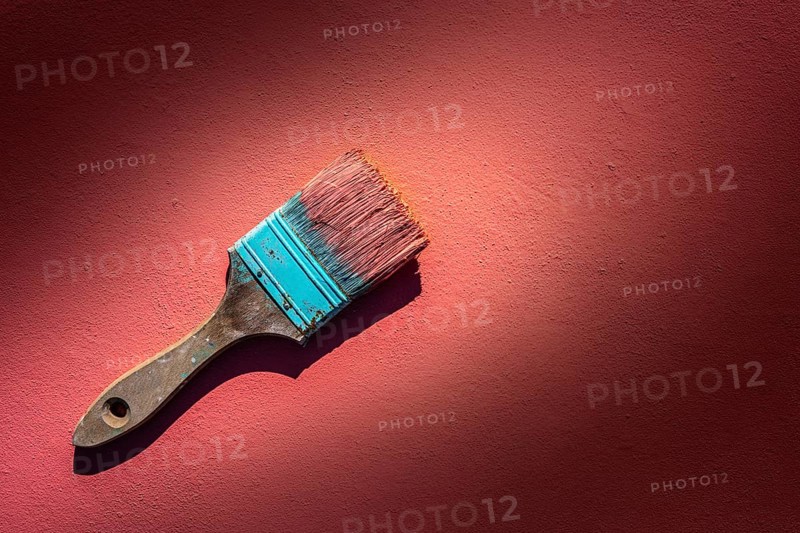 Coral color grunge brush with paint in monochromatic coral background wall
