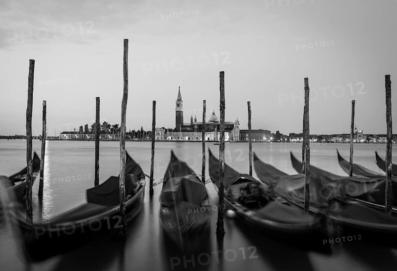 Moving Gondolas on Venice waterfront, San Giorgio Maggiore on the background