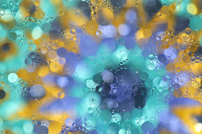 Oil on water over colourful background, pattern