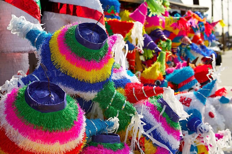 Mexican party pinatas decorated with fringed tissue colorful paper