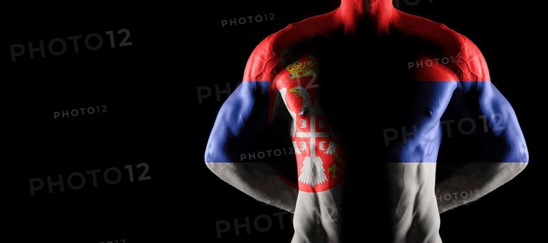 Serbia flag on muscled male torso with abs, black background