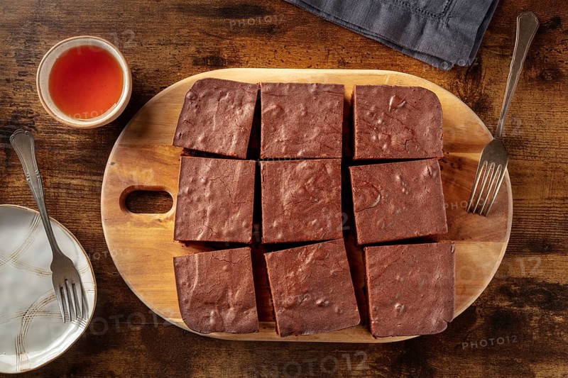 Chocolate brownie with tea, simple coffee cake, overhead flat lay view on a dark rustic wooden background, Food photography, Food photography