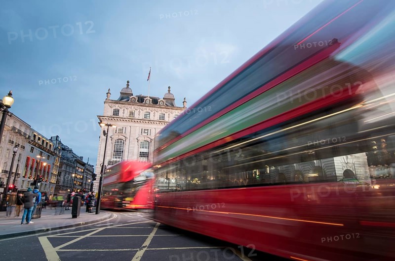 London, England, March 19, 2018: Night scene from the famous London Piccadilly circus square at the centre of London with cars and buses leaving colorful light traces