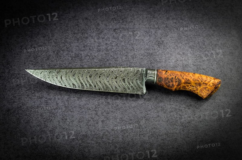 Beautiful luxurious utility knife in Texas Wind damask pattern with noble wood handle on dark background