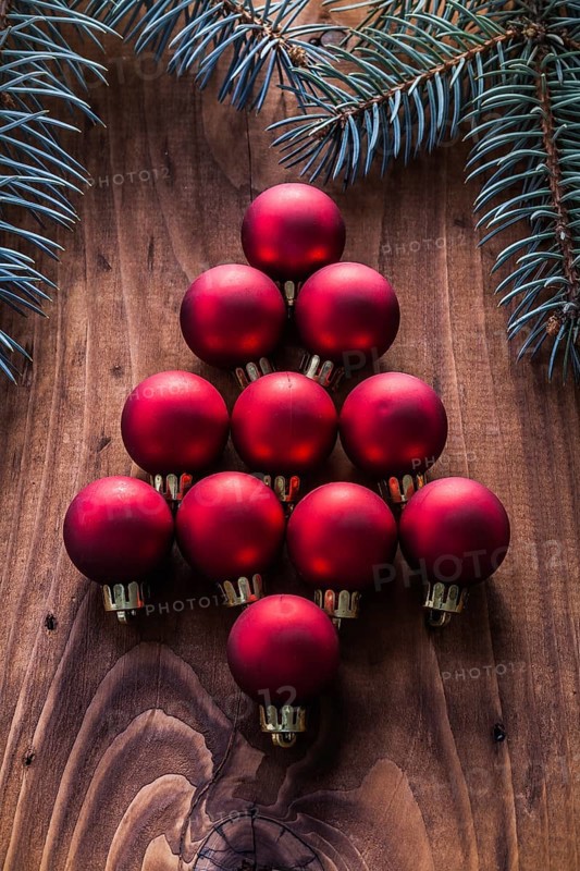 Red christmas baubles in the form of fir tree and branches firtree vintage wood board