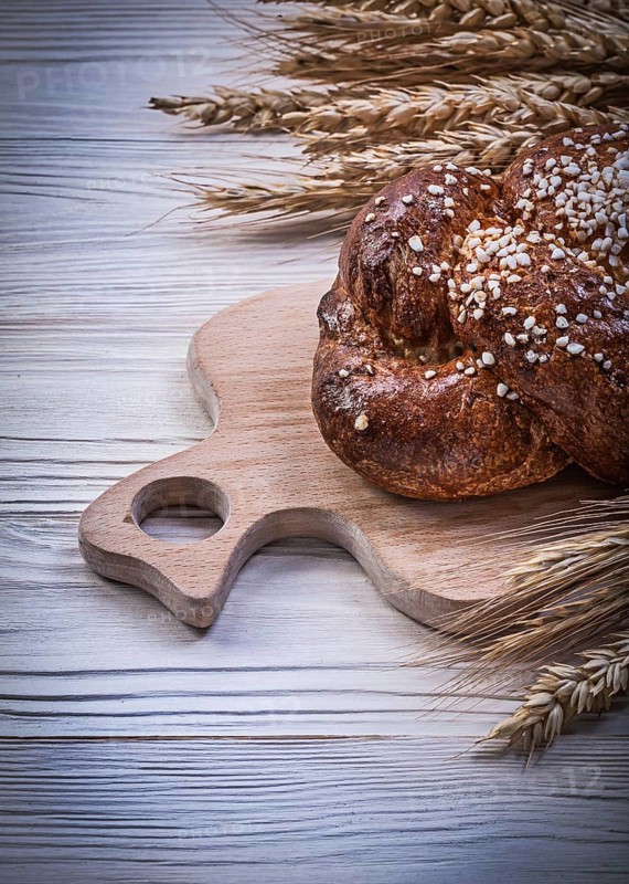 Chopping board wheat rye ears bread stick on wooden background food and drink concept