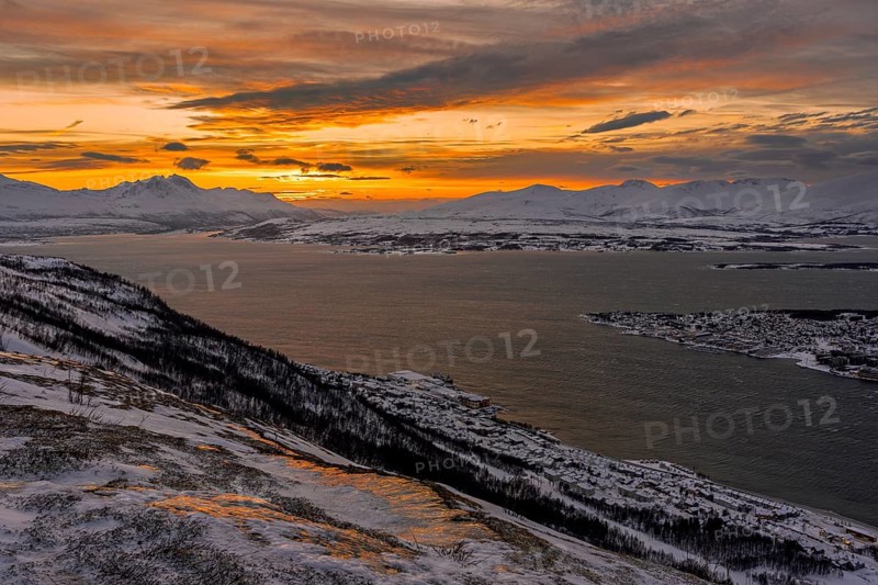 Winter view from Mount Storsteinen to the southern tip of Tromso at sunset, Troms, Norway, Europe