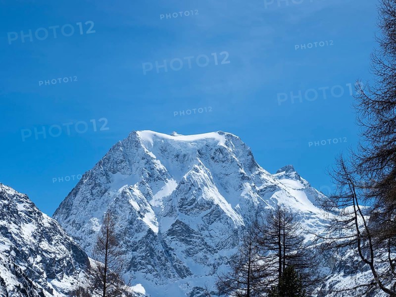 Beautiful view from Arolla, Switzerland, in winter: A high alpine peak with steep slopes covered with glaciers and rocks, Europe