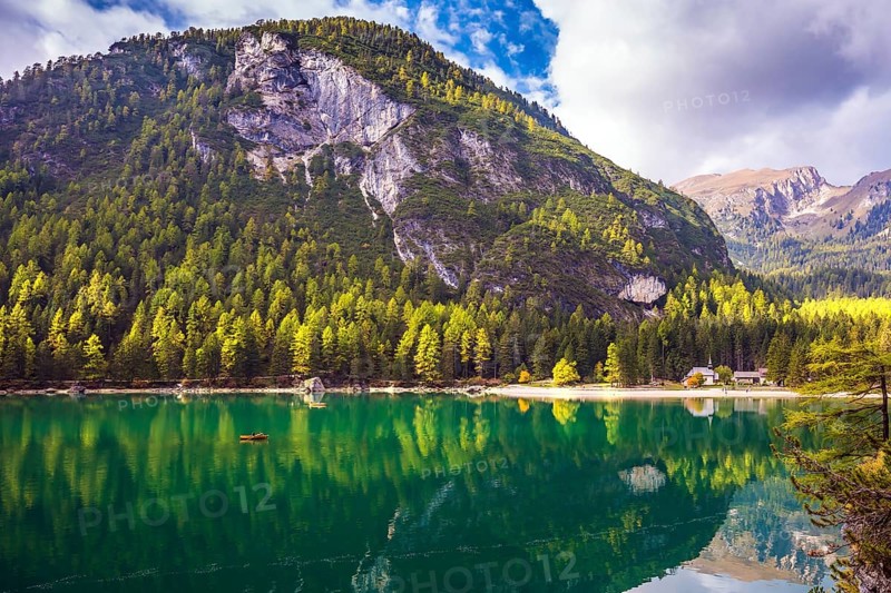 Magnificent lake Lago di Braies. Emerald expanse of water reflects the surrounding forest and mountains. The concept of walking and eco-tourism. South Tyrol, Italy, Europe
