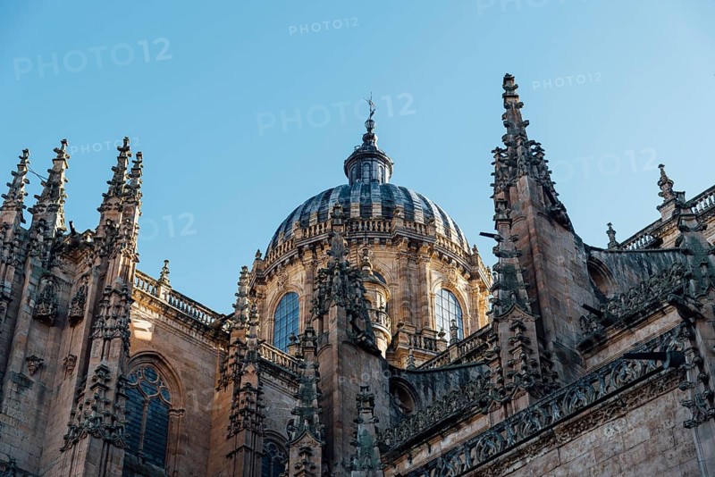 View of the roofs and dome of the Old Cathedral of Salamanca a blue sky day. Castilla y Leon, Spain, Europe