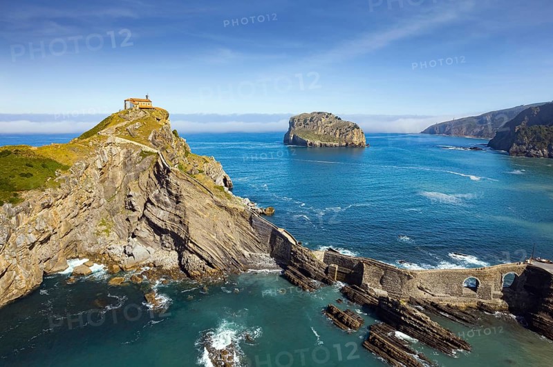 The most extraordinary coast of Spain. The island Gastelugache connected to the mainland by a bridge and winding staircase. Photo taken from a drone. Basque Country. Magical landscape