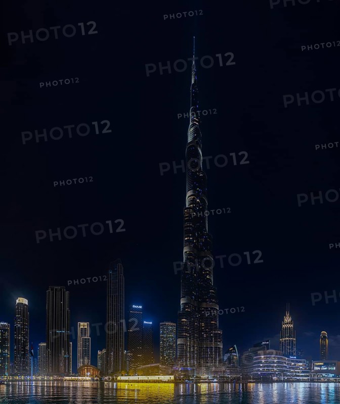 A picture of the iconic Burj Khalifa, and the surrounding Downtown Dubai buildings and Burj Khalifa Lake, at night