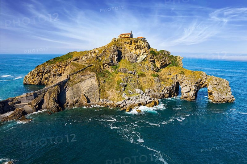 The island Gastelugache connected to the mainland by a bridge and a winding staircase. The Bay of Biscay, Basque Country. Magical unique landscape. Photo taken from a drone