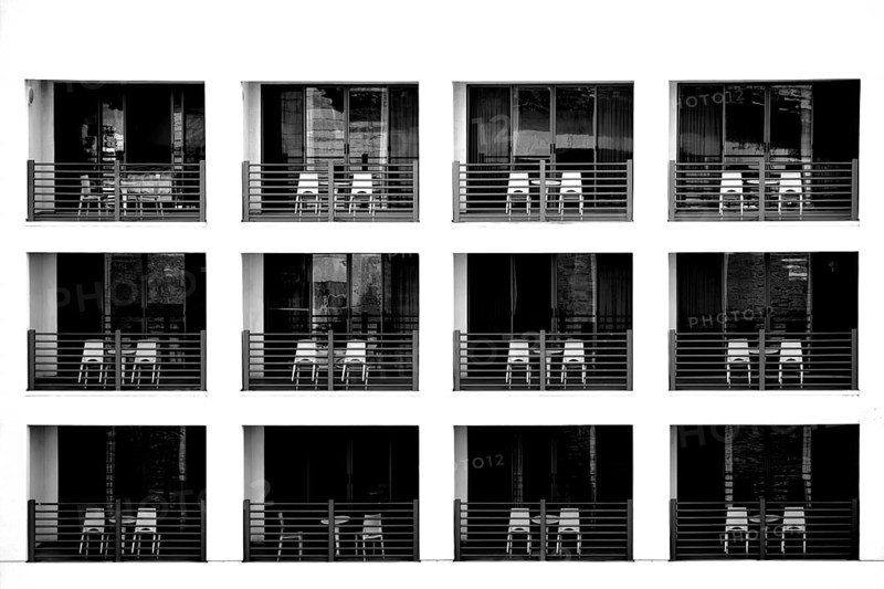 The exterior façade of a modern hotel with recessed balconies