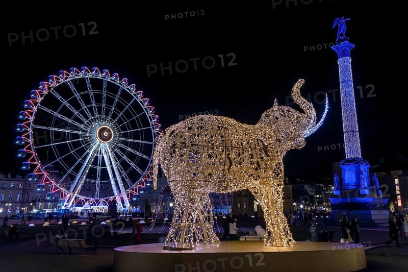 Schlossplatz decorated for Christmas in the evening, with illuminated figure of an elephant and in the background the Jubilee Column decorated with lights and the Ferris wheel decorated with lights, Stuttgart, Baden-Württemberg, Germany, Europe