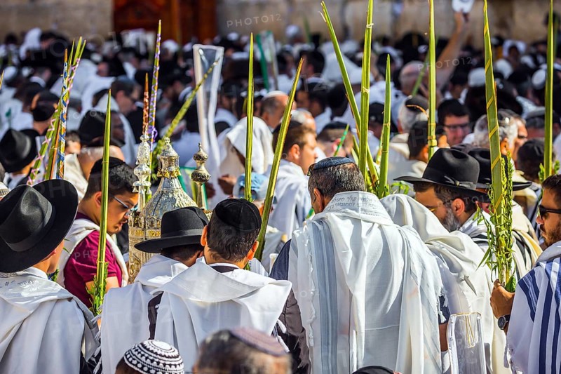 Jerusalem, Israel. Jews praying at the Western Wall wrapped in white Talit. Blessing of the Cohenim in Passover. Solemn celebratory ceremony at the Western slope of the Temple Mount. The concept of pilgrimage