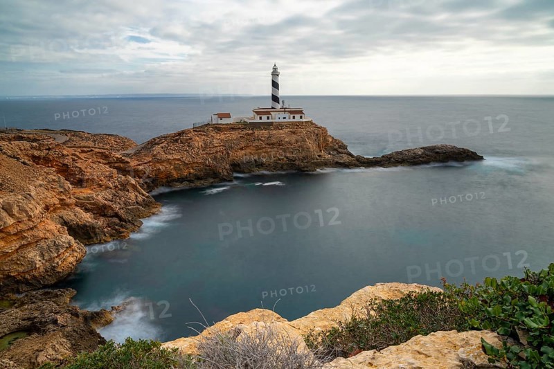 Long exposure view of the Cap de Cala Figuera lighthouse under an overcast sky
